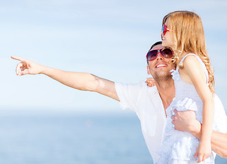 Image showing happy father and child in sunglasses over blue sky