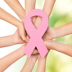 Image showing close up of hands with cancer awareness symbol