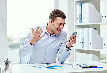 Image showing close up of businessman with smartphone