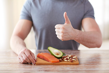 Image showing close up of male hands with food rich in protein