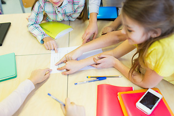 Image showing group of school kids pointing fingers to test