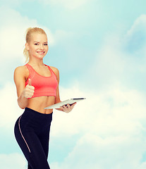 Image showing smiling sporty woman with tablet pc computer