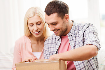 Image showing happy couple with parcel box at home