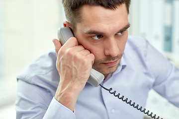 Image showing face of businessman calling on phone in office