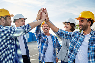 Image showing close up of builders in hardhats making high five