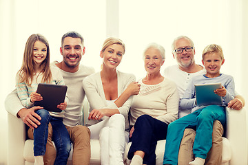 Image showing smiling family with tablet pc at home