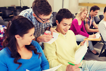 Image showing group of smiling students in lecture hall