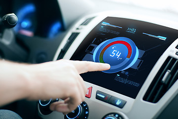 Image showing hand setting volume on car audio stereo system