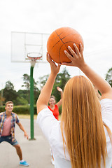 Image showing group of happy teenagers playing basketball