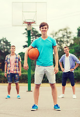 Image showing group of smiling teenagers playing basketball