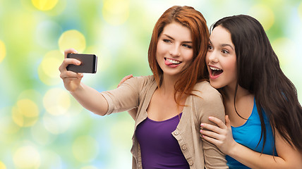 Image showing happy teenage girls taking selfie with smartphone