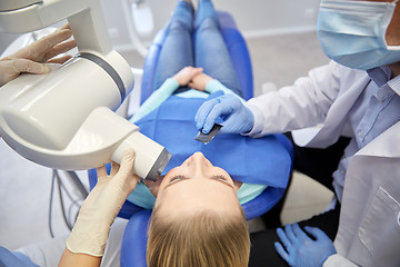 Image showing dentist and patient with dental x-ray machine