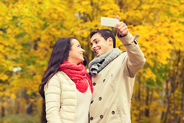 Image showing smiling couple hugging in autumn park