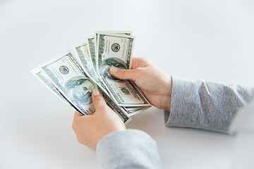 Image showing close up of woman hands counting us dollar money