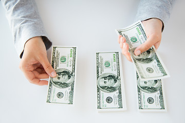 Image showing close up of woman hands counting us dollar money