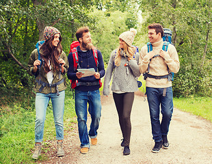 Image showing group of smiling friends with backpacks hiking