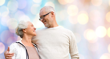 Image showing happy senior couple over holidays lights