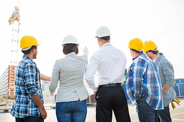 Image showing group of builders and architects at building site