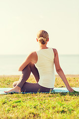 Image showing woman making yoga exercises outdoors