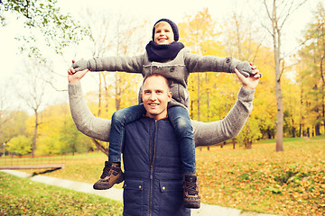 Image showing happy family having fun in autumn park