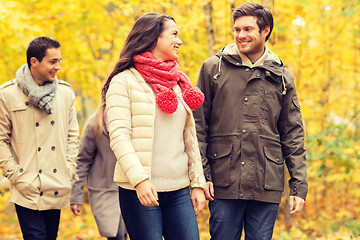 Image showing group of smiling men and women in autumn park