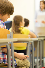 Image showing school boy with smartphone on lesson at classroom