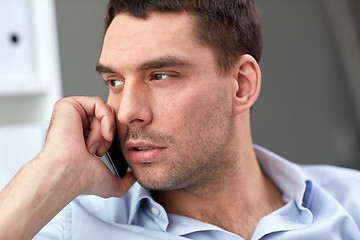 Image showing face of young businessman calling on smartphone