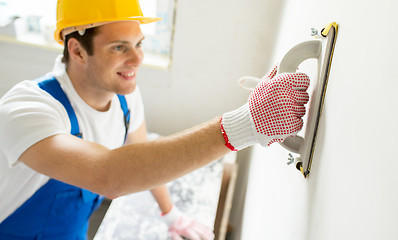 Image showing close up of builder working with grinding tool