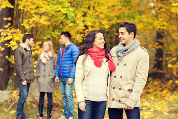 Image showing group of smiling men and women in autumn park