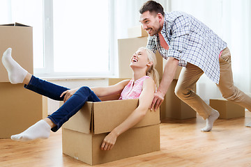 Image showing couple with cardboard boxes having fun at new home