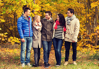 Image showing group of smiling men and women in autumn park