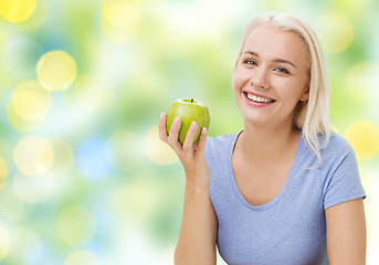 Image showing happy woman eating green apple