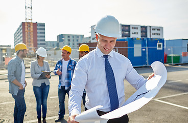 Image showing architect with blueprint on construction site