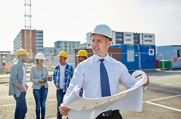 Image showing architect with blueprint on construction site