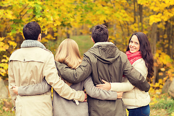 Image showing group of smiling men and women in autumn park