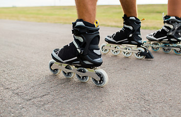 Image showing close up of legs in rollerskates skating on road