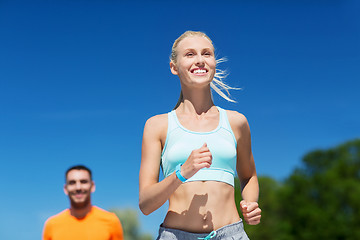 Image showing smiling couple running outdoors