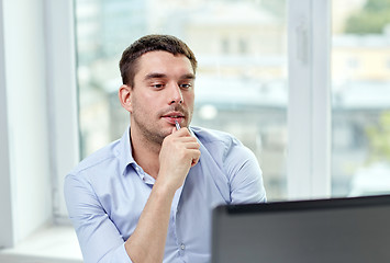 Image showing young businessman with laptop computer at office