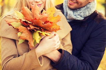 Image showing close up of smiling couple hugging in autumn park