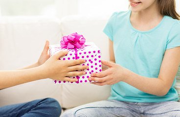 Image showing close up of girls with birthday present at home