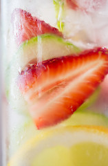 Image showing close up of fruit water in glass bottle