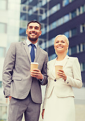 Image showing smiling businessmen with paper cups outdoors