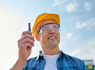 Image showing close up of builder in hardhat with walkie talkie