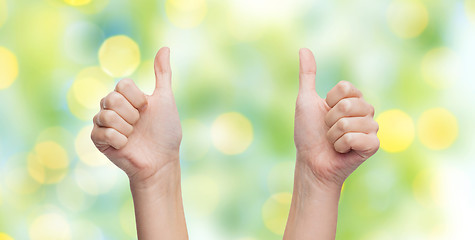 Image showing woman hands showing thumbs up over blue sky