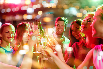 Image showing smiling friends with wine glasses and beer in club