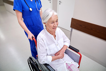 Image showing nurse with senior woman in wheelchair at hospital