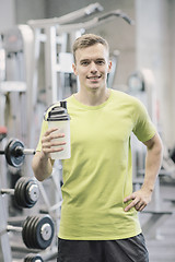 Image showing smiling man with protein shake bottle