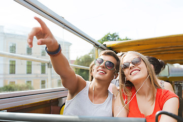 Image showing happy teenage couple traveling by tour bus