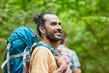 Image showing group of smiling friends with backpacks hiking