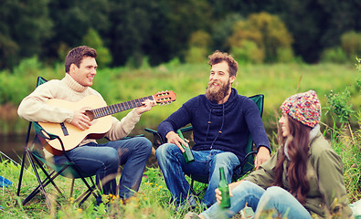 Image showing group of tourists playing guitar in camping